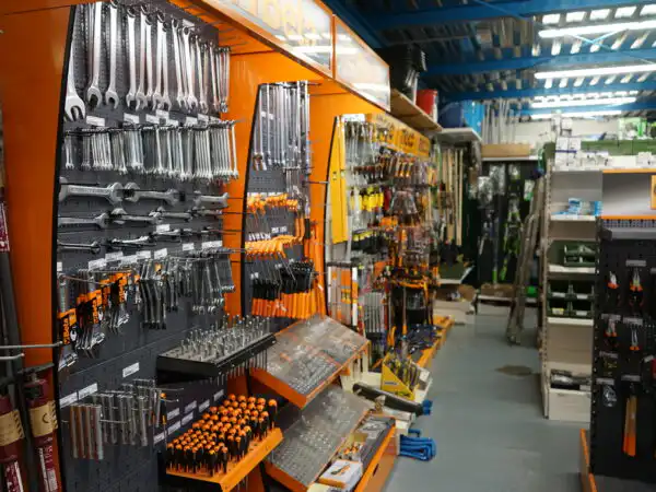 Corsia interna del reparto ferramenta con pannelli di chiavi, cacciaviti e utensili a mano